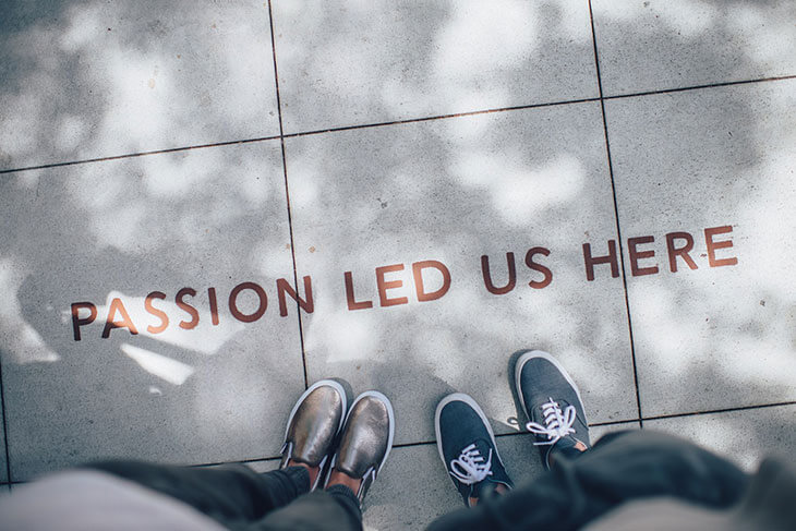 “Passion led us here” written on a paved walkway